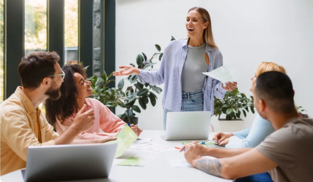 Young woman giving a presentation to an audience.
