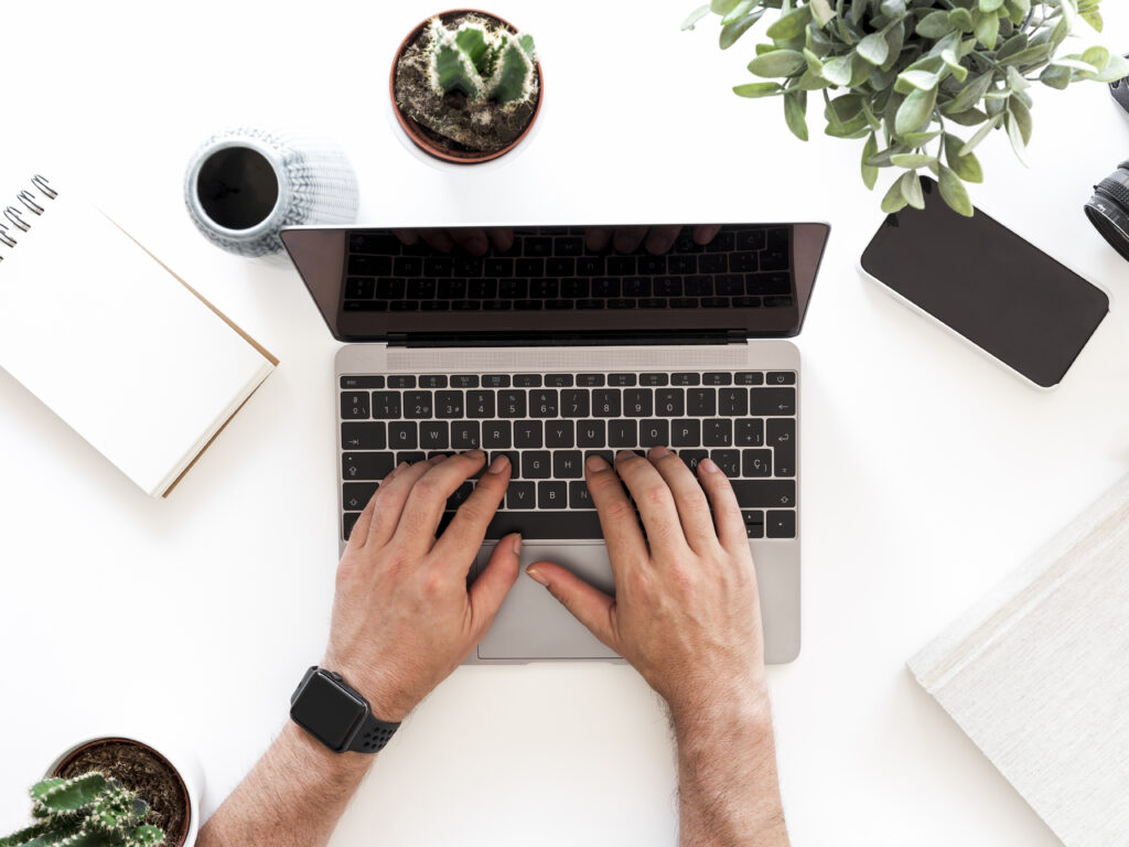 Blog Picture of a person writing on his laptop. "Blog" is written on it.